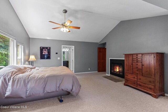 7722 W Clemetson Rd, Coeur Dalene, ID 83814 - bedroom with vaulted ceiling, light colored carpet, multiple windows, and a fireplace with flush hearth