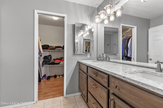 7722 W Clemetson Rd, Coeur Dalene, ID 83814 - bathroom featuring double vanity, a walk in closet, and tile patterned floors