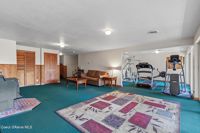 7722 W Clemetson Rd, Coeur Dalene, ID 83814 - carpeted living room with a textured ceiling and wooden walls