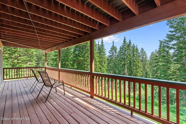 7722 W Clemetson Rd, Coeur Dalene, ID 83814 - wooden terrace featuring a forest view
