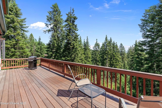7722 W Clemetson Rd, Coeur Dalene, ID 83814 - wooden deck featuring grilling area and a wooded view