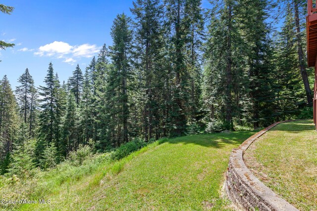 7722 W Clemetson Rd, Coeur Dalene, ID 83814 - view of grassy yard featuring a forest view