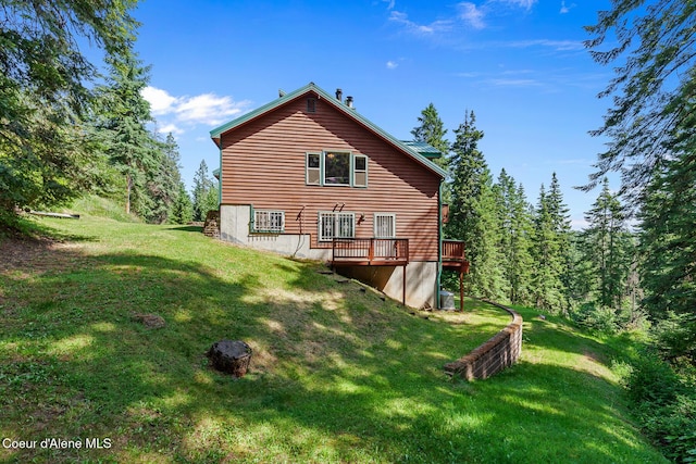 7722 W Clemetson Rd, Coeur Dalene, ID 83814 - rear view of house with a lawn and a deck
