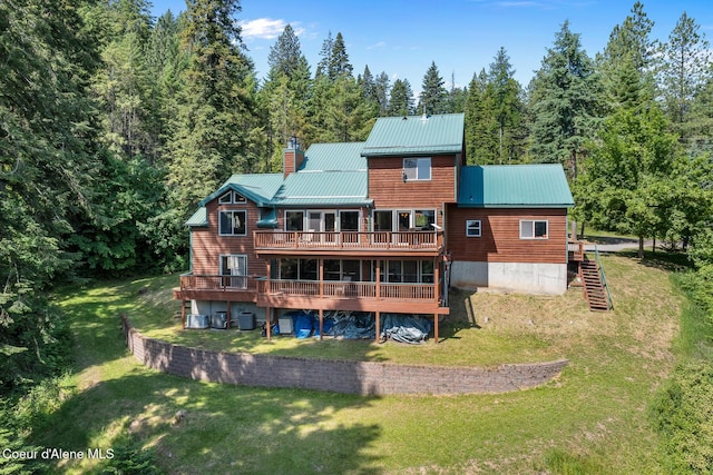 7722 W Clemetson Rd, Coeur Dalene, ID 83814 - rear view of house with a chimney, a wooden deck, stairway, and a yard