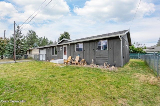 1503 E 3rd Ave, Post Falls, ID 83854 - back of property with a fenced backyard, a garage, and board and batten siding