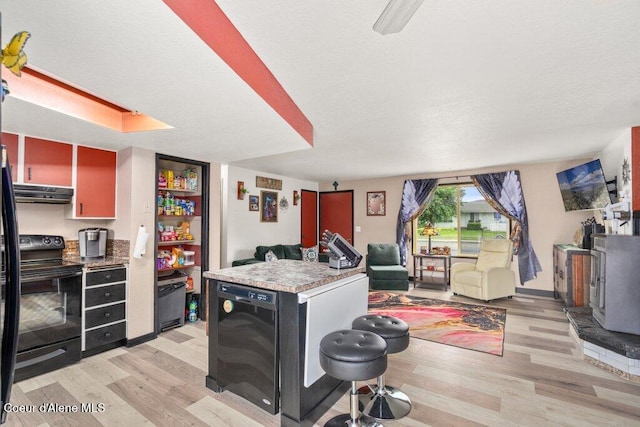 1503 E 3rd Ave, Post Falls, ID 83854 - kitchen with black appliances, open floor plan, light wood-style floors, and extractor fan