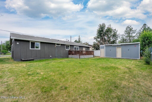 1503 E 3rd Ave, Post Falls, ID 83854 - back of property with board and batten siding, a yard, a shed, and a deck