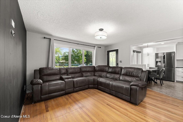 502 W 14th Ave, Post Falls, ID 83854 - living room featuring light wood finished floors and a textured ceiling