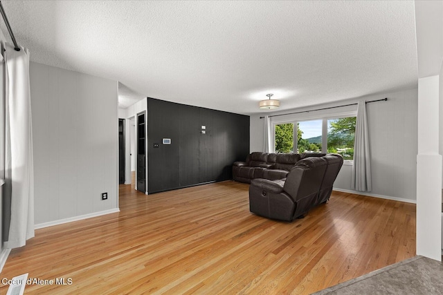 502 W 14th Ave, Post Falls, ID 83854 - living room with light wood-type flooring and a textured ceiling