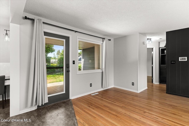 502 W 14th Ave, Post Falls, ID 83854 - interior space featuring a textured ceiling and light wood-style floors