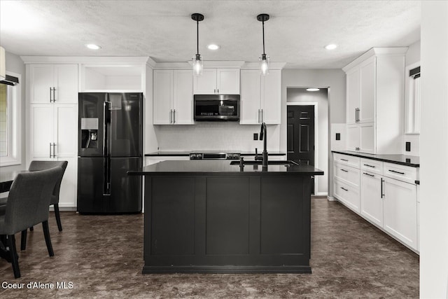 502 W 14th Ave, Post Falls, ID 83854 - kitchen featuring black refrigerator with ice dispenser, stainless steel microwave, dark countertops, backsplash, and white cabinetry