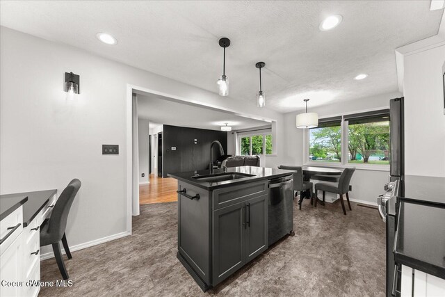 502 W 14th Ave, Post Falls, ID 83854 - kitchen featuring dishwasher, dark countertops, recessed lighting, pendant lighting, and a textured ceiling
