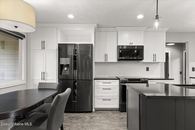 502 W 14th Ave, Post Falls, ID 83854 - kitchen featuring appliances with stainless steel finishes, dark countertops, tasteful backsplash, white cabinets, and recessed lighting
