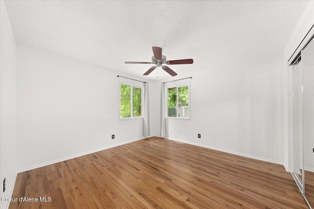 502 W 14th Ave, Post Falls, ID 83854 - unfurnished room with wood finished floors, a textured ceiling, and a ceiling fan