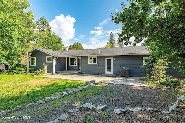 502 W 14th Ave, Post Falls, ID 83854 - back of house with a patio area, a lawn, and a chimney