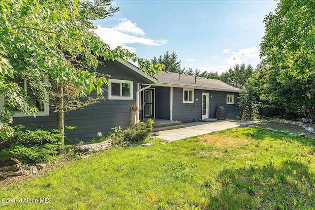 502 W 14th Ave, Post Falls, ID 83854 - back of property with a yard and a patio area