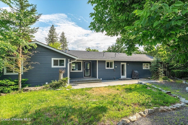 502 W 14th Ave, Post Falls, ID 83854 - rear view of property with a patio area and a lawn