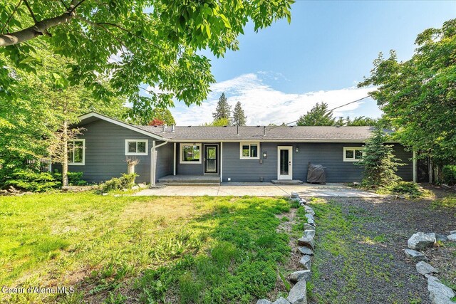 502 W 14th Ave, Post Falls, ID 83854 - back of house with a patio and a yard