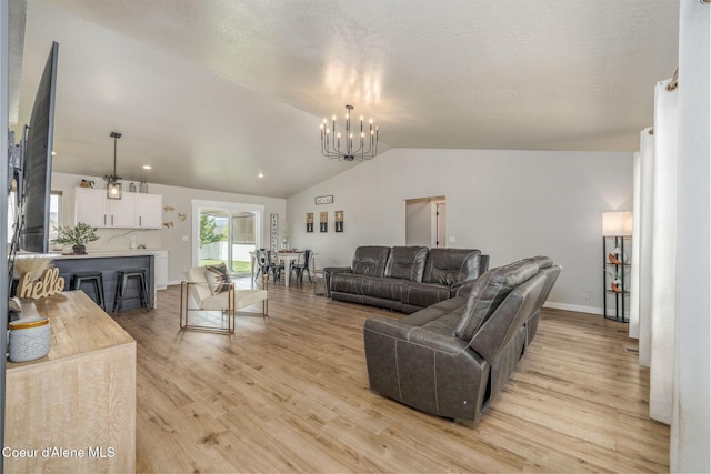 13417 N Halley St, Rathdrum, ID 83858 - living area featuring a chandelier, light wood-type flooring, and lofted ceiling