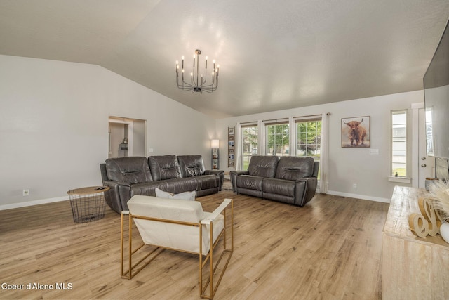 13417 N Halley St, Rathdrum, ID 83858 - living area with a chandelier, lofted ceiling, and light wood-style flooring