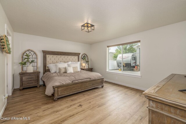 13417 N Halley St, Rathdrum, ID 83858 - bedroom with light wood-style flooring and baseboards