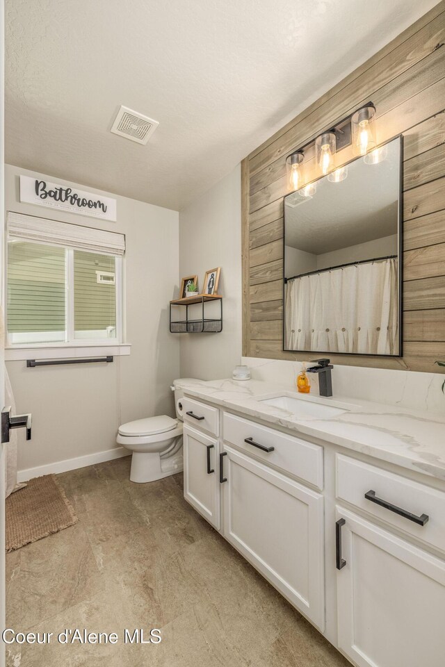 13417 N Halley St, Rathdrum, ID 83858 - bathroom featuring vanity and wood walls
