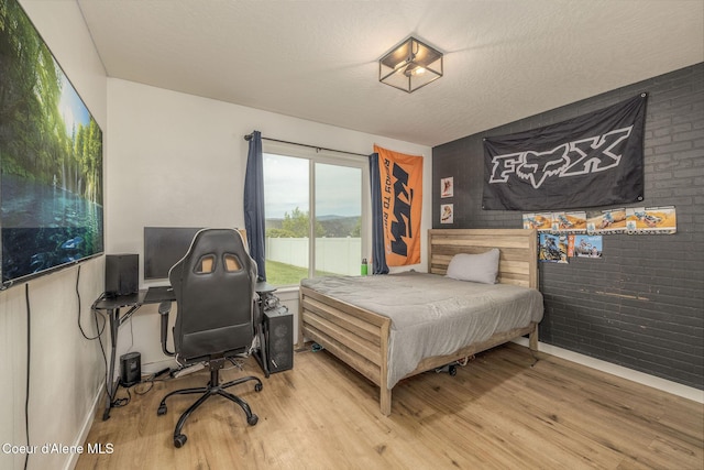 13417 N Halley St, Rathdrum, ID 83858 - bedroom with wood finished floors and an office area