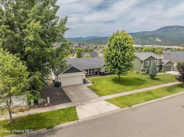 13417 N Halley St, Rathdrum, ID 83858 - view of front of home featuring concrete driveway, a mountain view, a residential view, and a garage