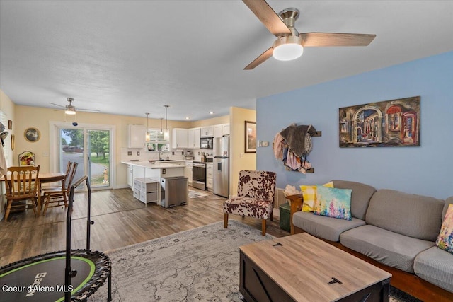 2270 W Linda Way, Post Falls, ID 83854 - living area featuring a ceiling fan, wood finished floors, and recessed lighting
