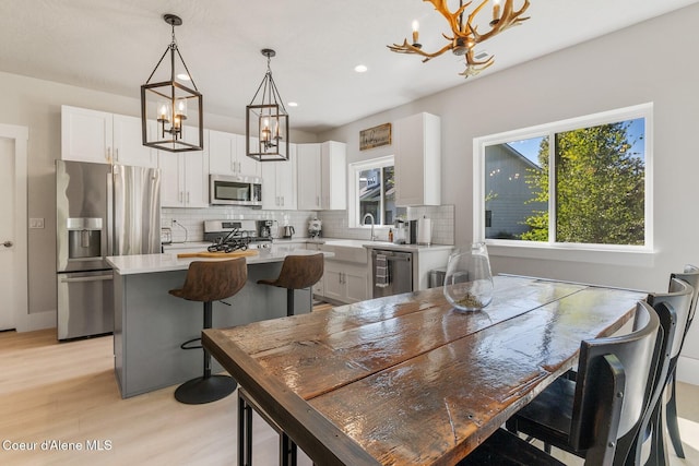 52 Peggys Ct, Dover, ID 83825 - dining space with a chandelier, healthy amount of natural light, recessed lighting, and light wood finished floors
