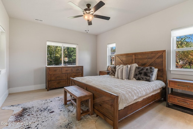 52 Peggys Ct, Dover, ID 83825 - bedroom featuring multiple windows, light wood-type flooring, and a ceiling fan