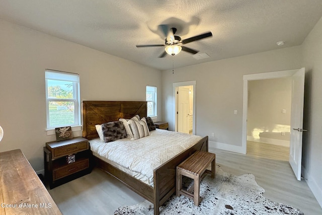 52 Peggys Ct, Dover, ID 83825 - bedroom with light wood-style flooring, multiple windows, a ceiling fan, and a textured ceiling