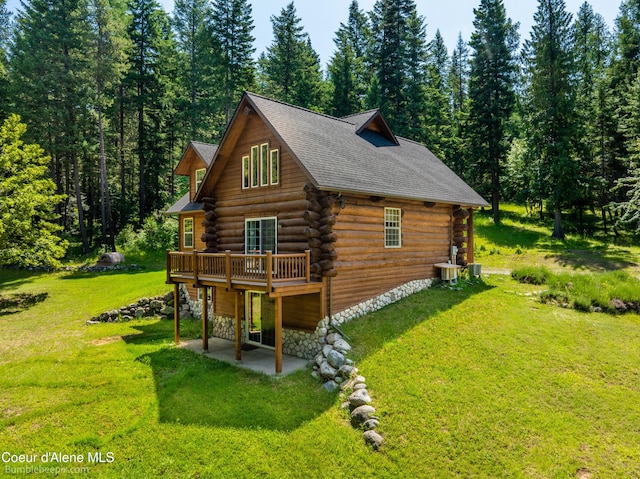 4900 E Hudlow Rd, Hayden, ID 83835 - view of side of property with a patio area, log siding, a yard, and a deck