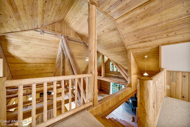 4900 E Hudlow Rd, Hayden, ID 83835 - stairs featuring wood ceiling, wooden walls, lofted ceiling, and carpet floors