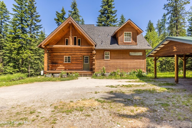 4900 E Hudlow Rd, Hayden, ID 83835 - log cabin featuring a shingled roof, covered porch, and log exterior