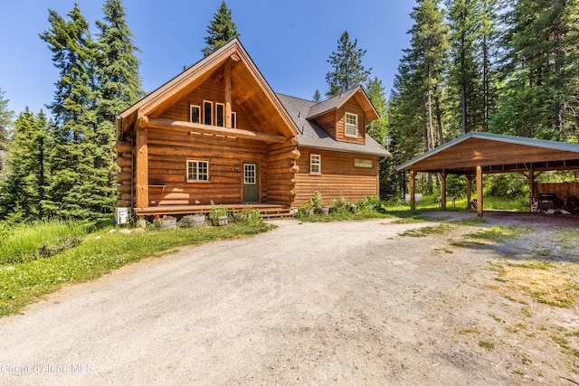 4900 E Hudlow Rd, Hayden, ID 83835 - log cabin with a carport, log exterior, and dirt driveway