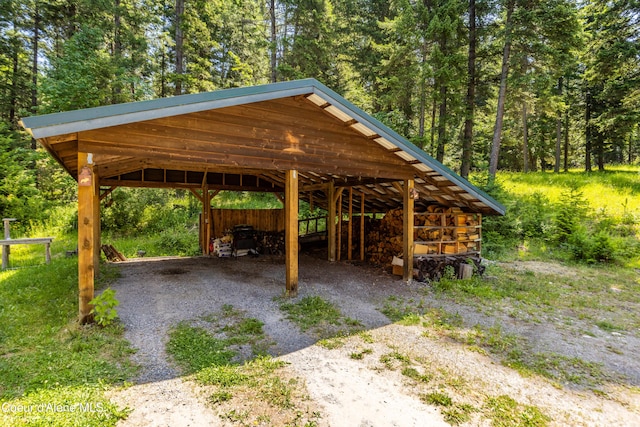 4900 E Hudlow Rd, Hayden, ID 83835 - view of property's community featuring a detached carport, driveway, and a wooded view