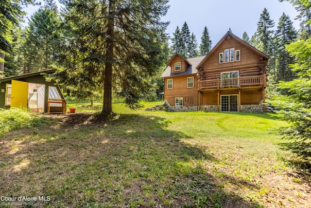 4900 E Hudlow Rd, Hayden, ID 83835 - rear view of property with a yard, stone siding, and a deck