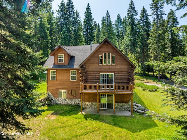 4900 E Hudlow Rd, Hayden, ID 83835 - rear view of house with a yard, stone siding, a patio, a deck, and a wooded view