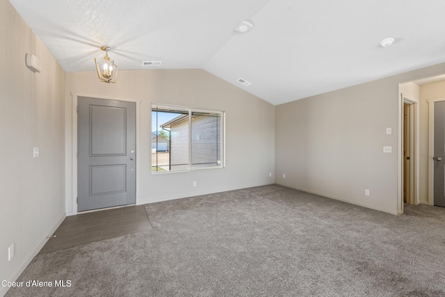 10519 Liverpool Loop, Hayden, ID 83835 - empty room with carpet floors, vaulted ceiling, and a chandelier