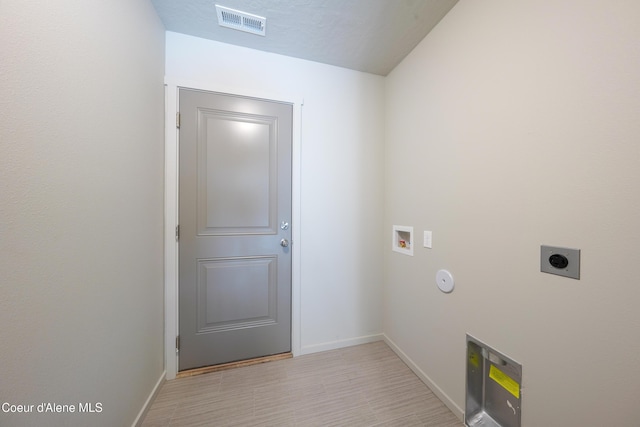 10519 Liverpool Loop, Hayden, ID 83835 - laundry room with hookup for an electric dryer, hookup for a washing machine, and light wood-type flooring