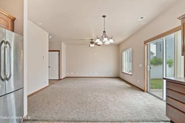 7833 N Hilliard Ct, Coeur Dalene, ID 83815 - unfurnished dining area featuring a chandelier, light carpet, and a ceiling fan