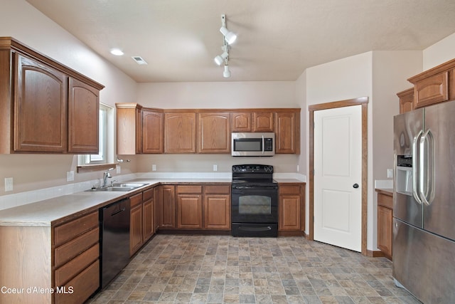 7833 N Hilliard Ct, Coeur Dalene, ID 83815 - kitchen with black appliances, stone finish floors, light countertops, and brown cabinets