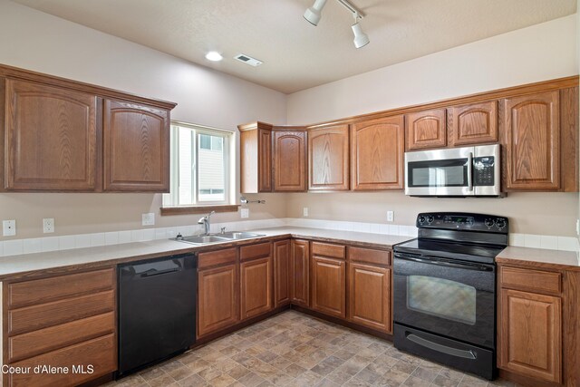 7833 N Hilliard Ct, Coeur Dalene, ID 83815 - kitchen featuring black appliances, brown cabinetry, light countertops, and rail lighting