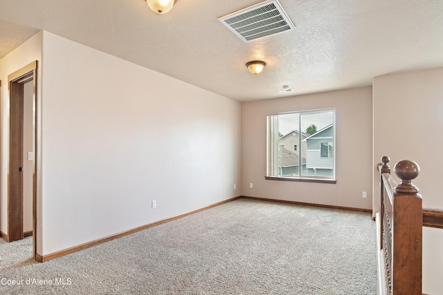 7833 N Hilliard Ct, Coeur Dalene, ID 83815 - unfurnished room with light colored carpet and a textured ceiling