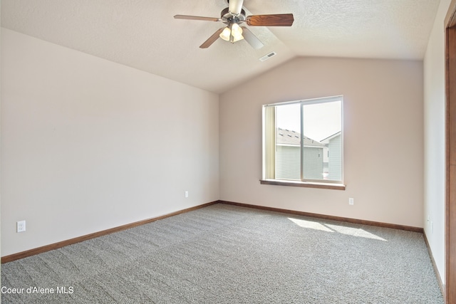 7833 N Hilliard Ct, Coeur Dalene, ID 83815 - empty room with carpet floors, ceiling fan, lofted ceiling, and a textured ceiling