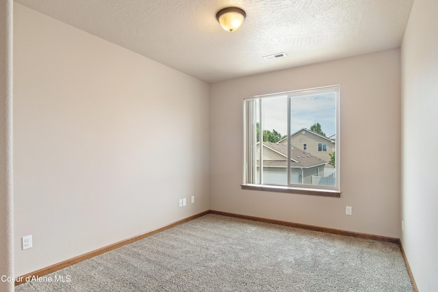 7833 N Hilliard Ct, Coeur Dalene, ID 83815 - carpeted empty room with baseboards and a textured ceiling