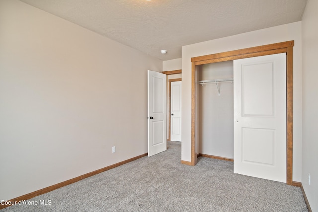 7833 N Hilliard Ct, Coeur Dalene, ID 83815 - unfurnished bedroom with carpet floors, a closet, and a textured ceiling