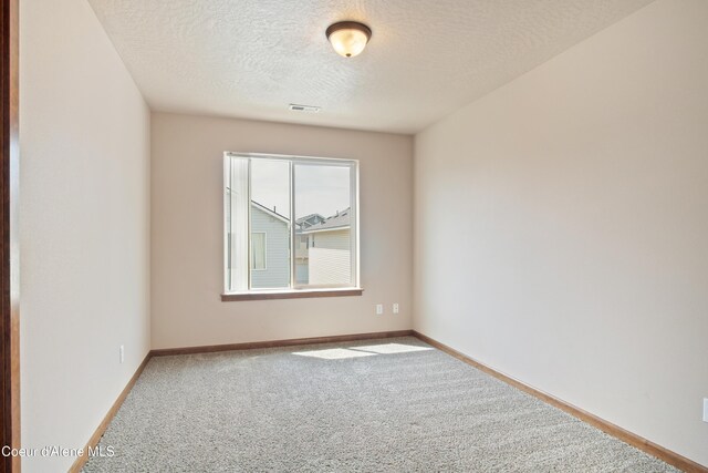 7833 N Hilliard Ct, Coeur Dalene, ID 83815 - spare room with carpet and a textured ceiling