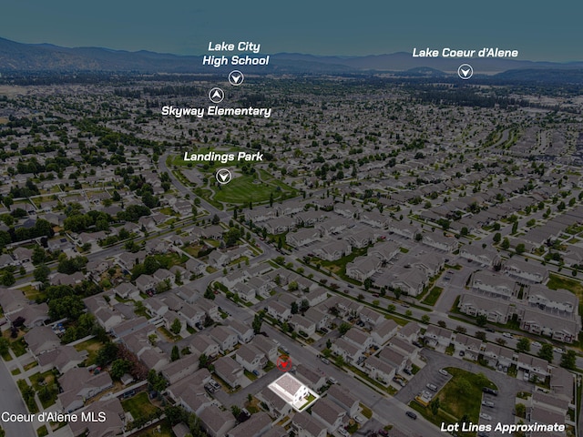 7833 N Hilliard Ct, Coeur Dalene, ID 83815 - aerial view of property and surrounding area with a mountain backdrop and nearby suburban area